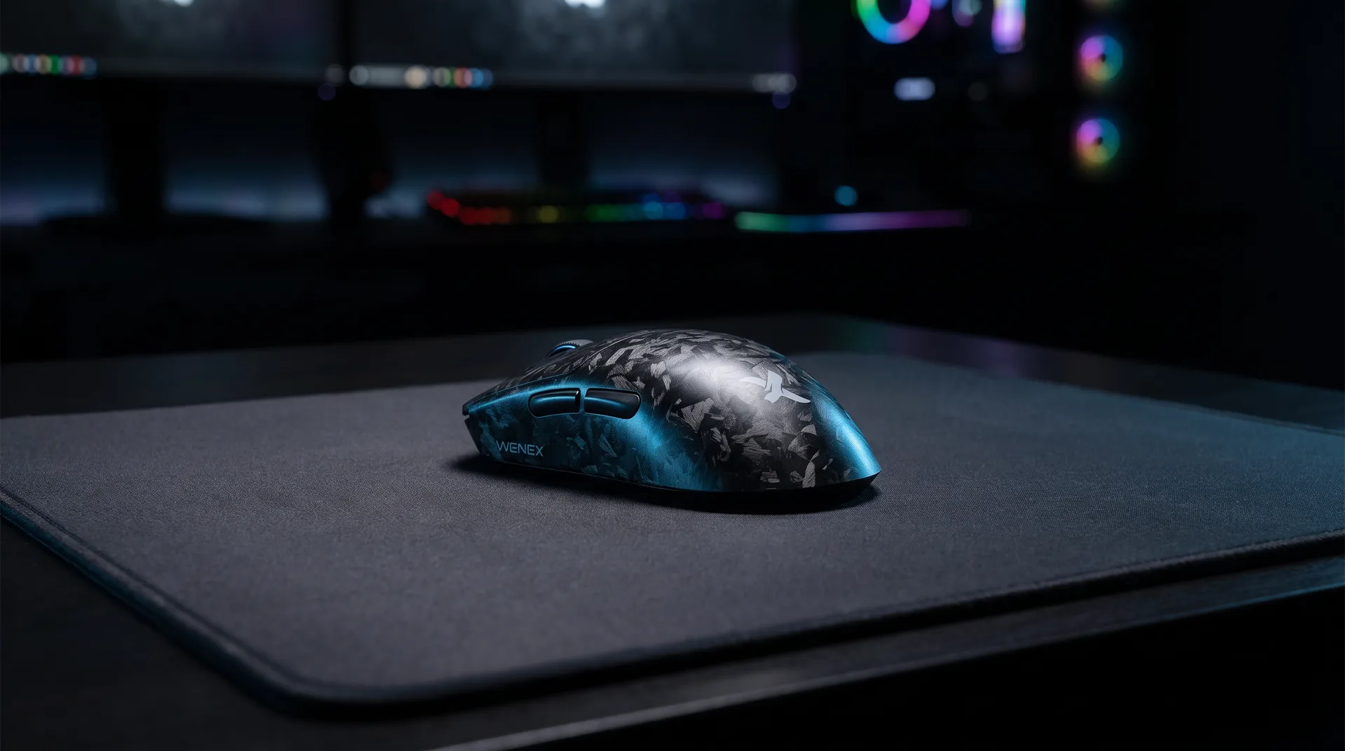 WENEX VECTOR gaming mouse on a cloth pad in a dim gaming setup
