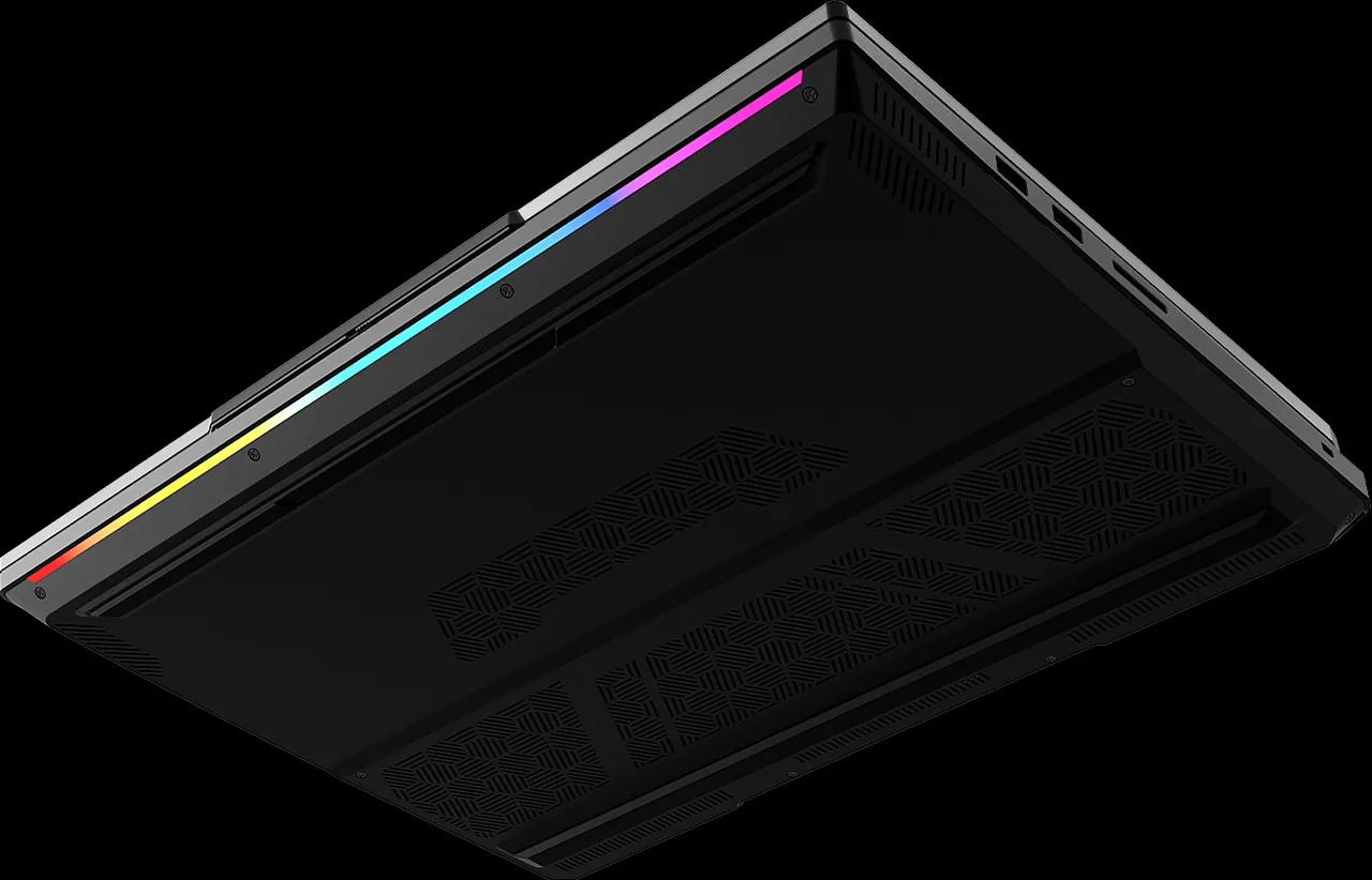 The WENEX NEXAR laptop closed and seen from below, showing the intake grilles across the underside and the front light bar along its edge